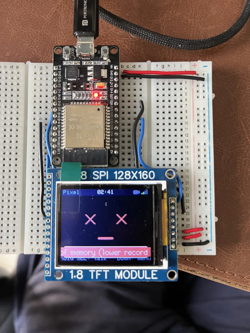 The device with X eyes and a flat mouth — its "dead" face — and a status bar reading "of memory (lower record", the tail of an out-of-memory message.